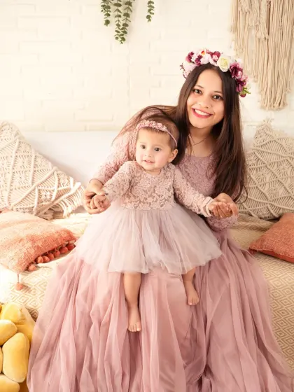 Twinning with mom! A mother and daughter in matching lace dresses share a special moment.