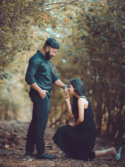 A romantic pose in a beautiful, secluded forest path. The way the trees form an arch creates a natural frame for this intimate moment.