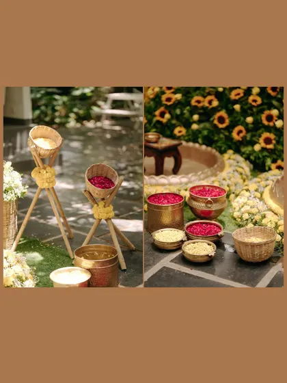 A detail shot of the Haldi decor, including bowls of turmeric and flower petals.