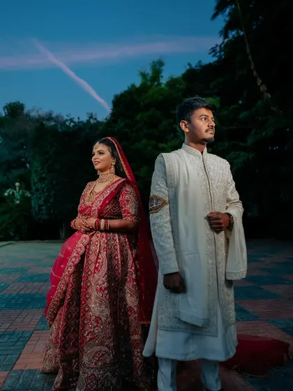 A regal bride in her magnificent red lehenga. We capture the grandeur of the bridal attire, creating portraits that are both powerful and elegant.