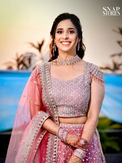 A radiant bride in her pink lehenga, smiling for the camera. We capture beautiful, classic bridal portraits that you will treasure forever.