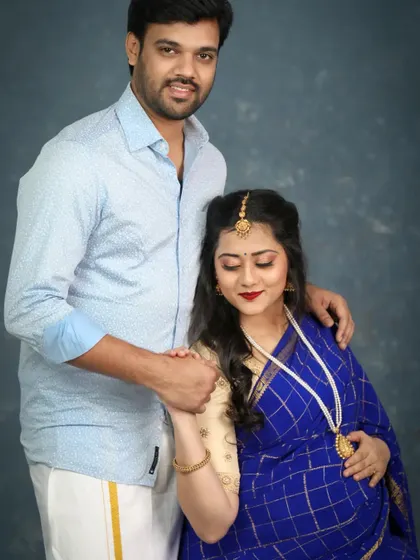 A sweet moment between an expecting couple during their traditional maternity session. He holds her hand gently, showing the love and support they share on this journey.
