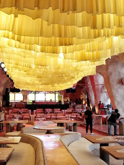 The venue before the party, with a ceiling of yellow fabric creating a sunny, beach-like atmosphere.