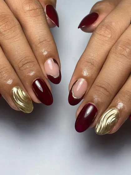 Bold and beautiful. This set combines a rich maroon polish with a statement nail in textured gold chrome for a luxurious and eye-catching look.