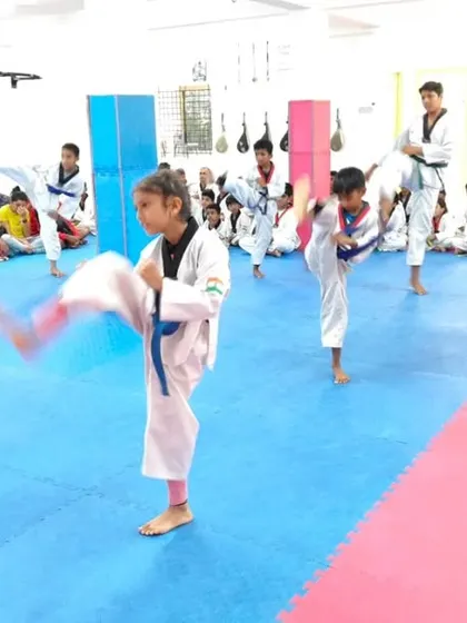 A student practices a high kick.