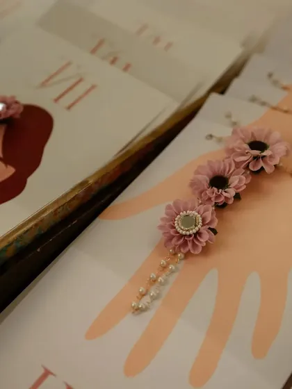 Custom-designed Mehendi invitations with matching floral bracelets for the guests.