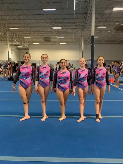The Xcel Gold team lines up at their first-ever sectional qualifier meet, focused and ready to compete.