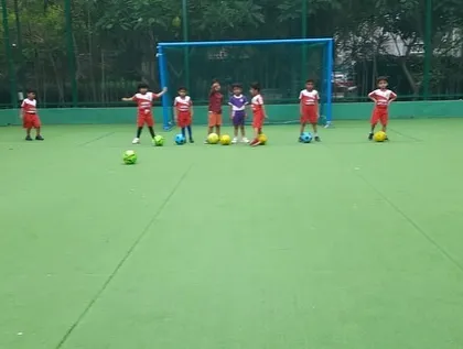 A group of toddlers lines up for a shooting drill, learning the fundamentals in a fun and interactive way.