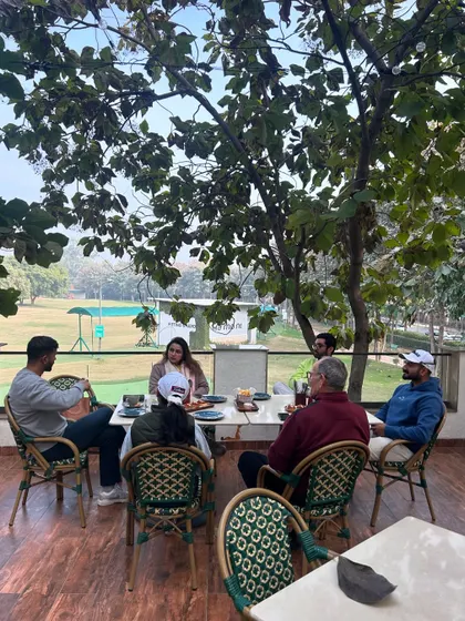 A team meeting that's anything but ordinary. The cafe's patio provides a refreshing setting for brainstorming sessions or casual discussions, with the greens as your backdrop.