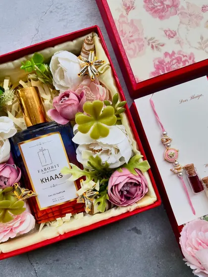 This Rakhi hamper includes a bottle of 'Khaas' perfume, adding a fragrant and luxurious touch to the traditional gift set.