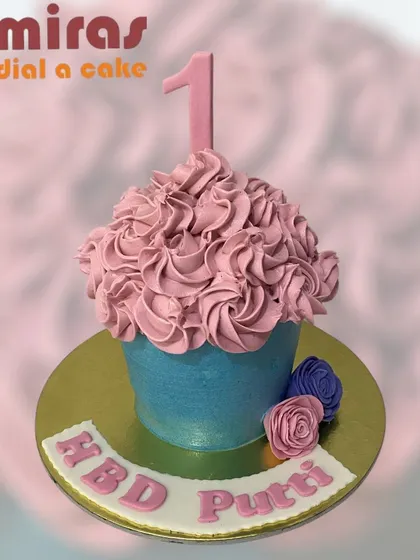 A cake shaped like a giant cupcake! This fun design is perfect for a first birthday, capturing all the charm of a cupcake in a size that's perfect for sharing.