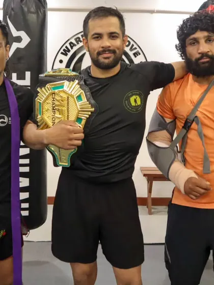 The spoils of war. Our champions and their coach, holding the title belts they fought and bled for. This is what our program produces.