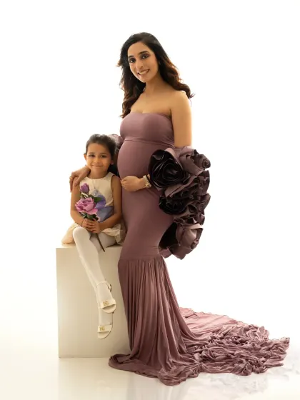 A full family portrait showcasing the gorgeous mauve gown. Having big sister sit on a posing block creates a lovely composition and keeps the focus on their connection.