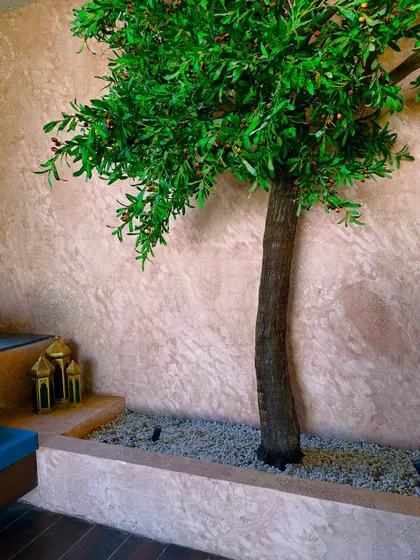 The artificial tree is a key feature, providing greenery and a sense of nature without the need for deep soil.
