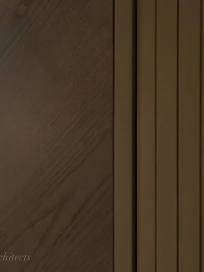 A detailed shot of the veneer and fluted paneling on the hidden bar cabinet. The precise craftsmanship and quality of the materials are what make a bespoke piece like this truly special.