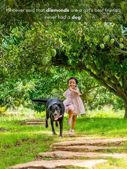 "Whoever said that diamonds are a girl's best friend never had a dog." A girl and her dog run happily down a path in a mango orchard.