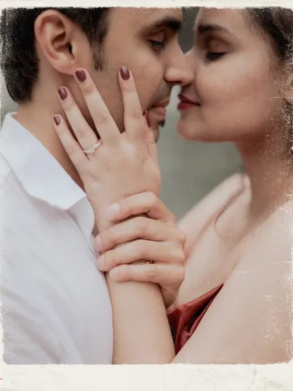 A close-up on the engagement ring and the couple's intimate embrace, set against a waterfall.