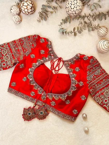 The back of the red Kanchi silk blouse, featuring a heart-shaped cutout and intricate embroidery.