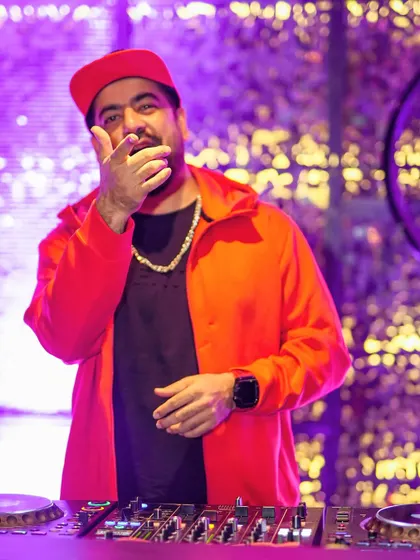 Pointing to the crowd, ready to drop the next beat. The connection with the audience is key.