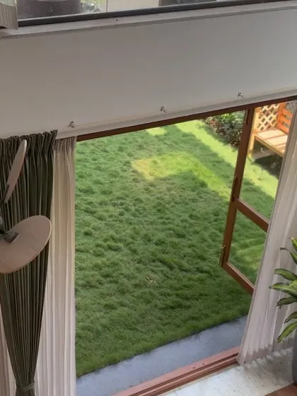 A view from the mezzanine level looking down towards the open garden, highlighting the vertical connection to nature.