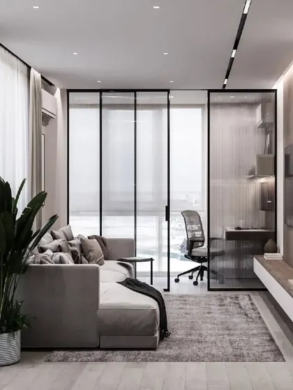 This design shows how a living area can be partitioned with glass to create a separate home office space. It maintains an open feel while providing a quiet, dedicated area for work.