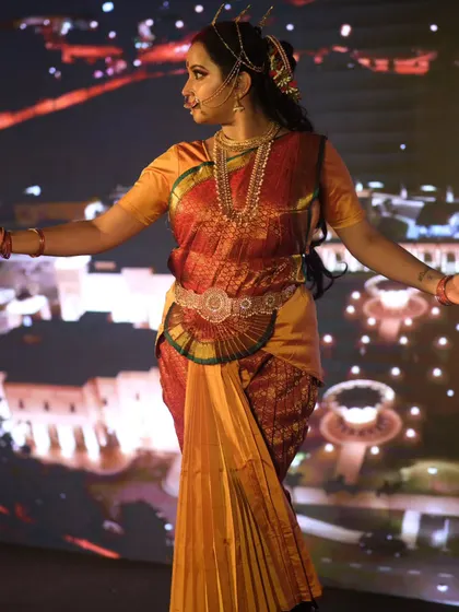 A three-quarter view of the Draupadi look, showing the traditional costume and jewellery. The makeup complements the rich colors of the saree and is designed for durability throughout the performance.