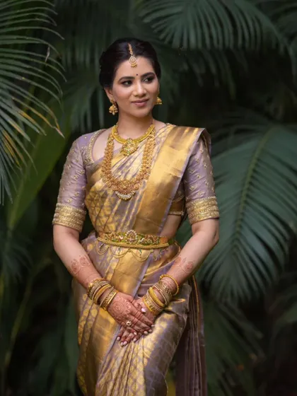 A poised and graceful portrait in a traditional saree, with makeup that enhances her natural features.