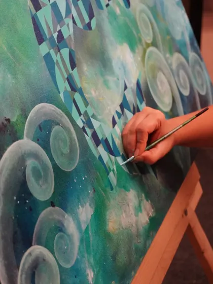 A close-up of my brushwork on the "Life Below Water" painting. Each stroke is precise, building up the geometric patterns and swirling blues that define the piece. This is where the vision starts to become a reality.