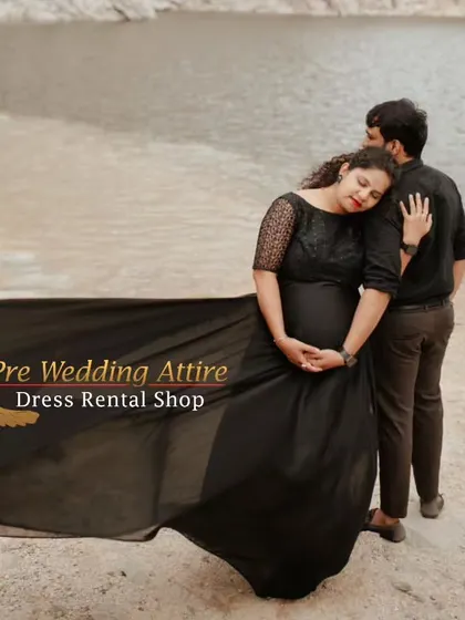 A tender moment captured with our black flying tail gown. The flowing train adds a soft, romantic element to this couple's waterside maternity portrait.