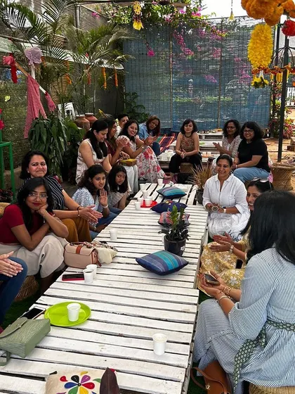 Guests gathered for a meal during a meet and greet. I focus on creating a communal dining experience that feels like a family gathering, with fresh food and great company.