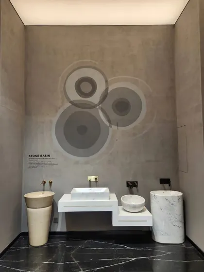 A minimalist and modern wall painting for a Jaquar showroom in Chandigarh. The subtle, overlapping circles on a textured grey wall create a sophisticated and artistic ambiance.