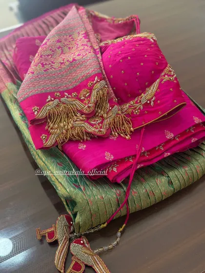 The back of the pink blouse, showing the dramatic tassels and latkans.