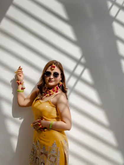 A modern and stylish Haldi portrait. We used the natural sunlight and shadows to create this cool, editorial-style photo of bride Nidhi.