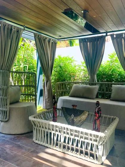 Another perspective of the pergola's interior, focusing on the custom furniture and decor. Every element is chosen to contribute to a cohesive and luxurious atmosphere.