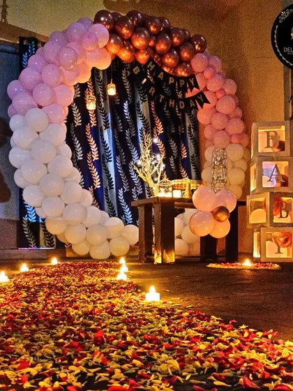 This is one of our popular romantic home birthday setups. It features a circular balloon arch, a "BABY" block display, and soft candlelight to create a cozy and intimate atmosphere perfect for a surprise celebration.