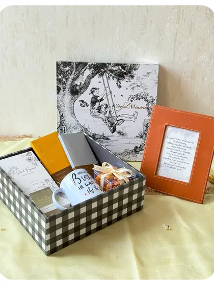 A thoughtful Rakhi hamper for a brother, including a "Best Brother" mug, a photo frame, and a selection of our treats.