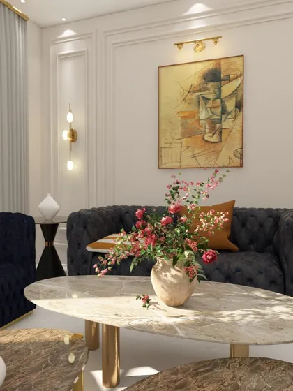 A close-up showing the beautiful textures in the living room, from the tufted sofa to the veining in the marble coffee table and the fresh flowers.