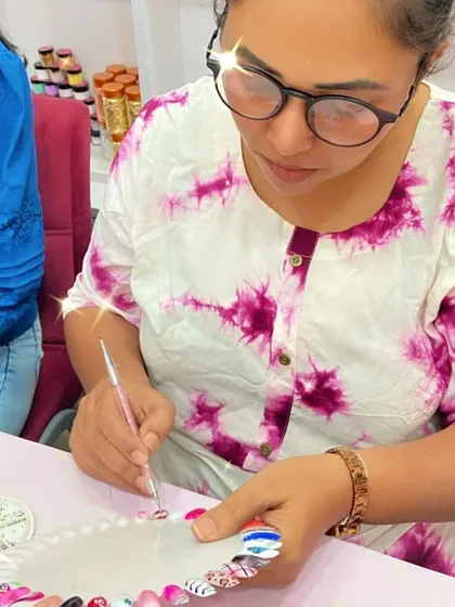 This student is practicing her nail art on a color wheel, experimenting with different designs and techniques.