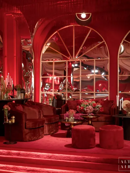 Our 'Le Rouge' sangeet in Doha was a contemporary take on boudoir burlesque. This lounge area is drenched in red velvet, with distorted mirrors and modern lighting creating a dramatic and sophisticated vibe.