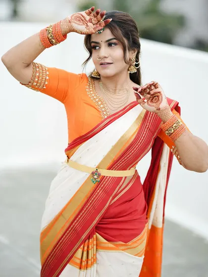 Another shot from the same series, where the simple henna design on the back of her hands perfectly matches the festive and bright colors of her outfit.