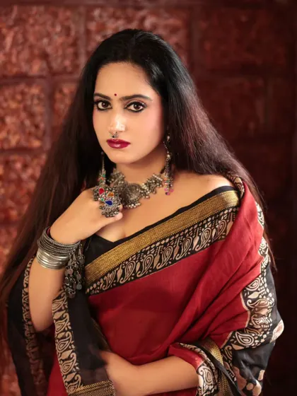 A striking portrait of a model with bold makeup and traditional silver jewelry. Her direct gaze and confident pose make this a powerful and captivating image.