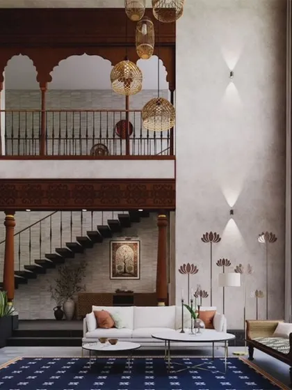 A view of the massive double-height living room in the Kanakapura Residence. We used brick cladding, Kota stone flooring, and a wooden jharokha to scale down the dramatic volume and create a cozy, traditional feel.