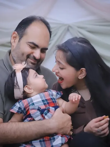 A playful interaction between a father, mother, and their toddler. Our studio sessions are all about capturing these natural connections.