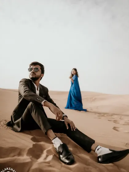 A creative shot with the groom in the foreground, creating depth and focusing on his perspective.