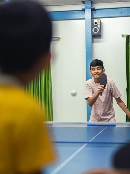 A young player enjoys a game of table tennis. It's one of our favorite indoor sports for developing quick reflexes and having fun.