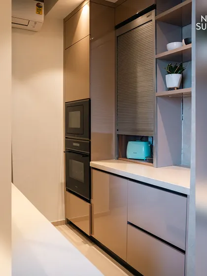 A detail of the appliance garage with a roll-up shutter, a feature we included to keep the countertop clutter-free. This smart storage solution is part of our commitment to functional, minimalist design.