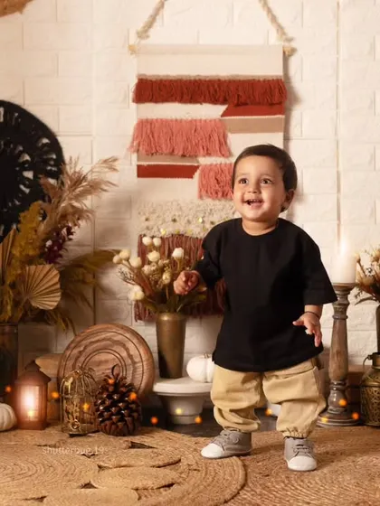 A baby's first steps are a huge milestone! This little one is standing tall and proud in our boho-chic studio.