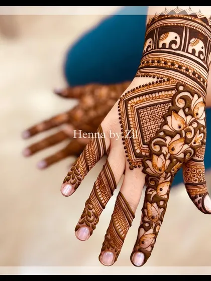 A beautiful back-hand design with lotus and elephant motifs, showing how the pattern wraps around the fingers.