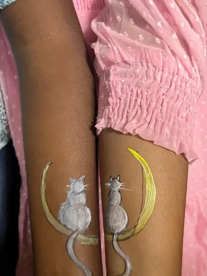 Matching cat tattoos for two friends at our adoption drive. It's a fun way for kids to show their love for animals and be a part of the day's excitement.