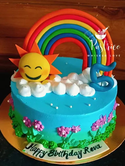 This bright and sunny rainbow cake is sure to bring a smile, with a happy sun peeking out from behind fluffy whipped cream clouds.